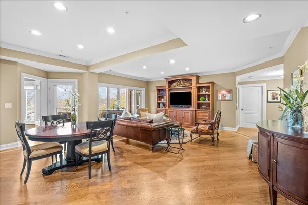 a living room with furniture dining room and wooden floor