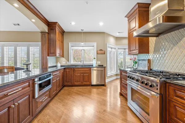 a kitchen with stainless steel appliances a stove a sink and a refrigerator
