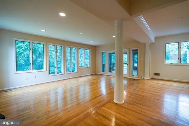 an empty room with a cabinet and mirrors