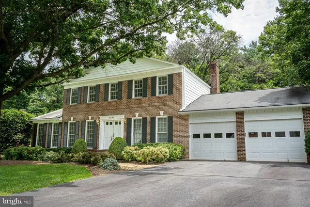 a white kitchen with cabinets and a refrigerator