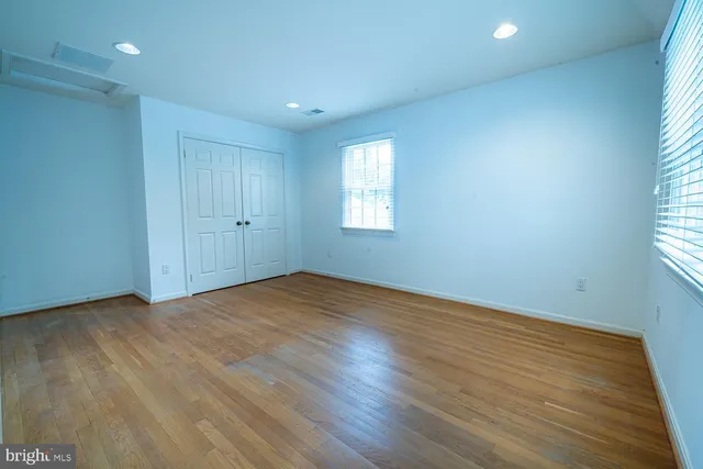 a view of a room with wooden floor