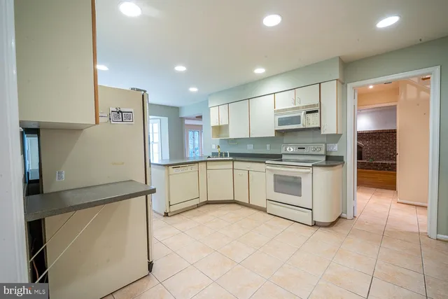 a kitchen that has a lot of cabinets in it and appliances
