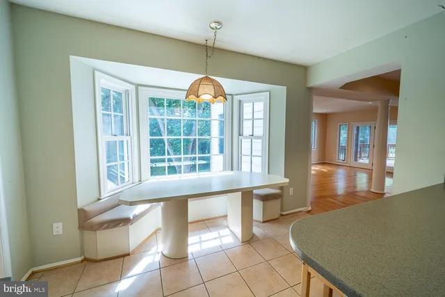 a view of an empty room with glass door and windows