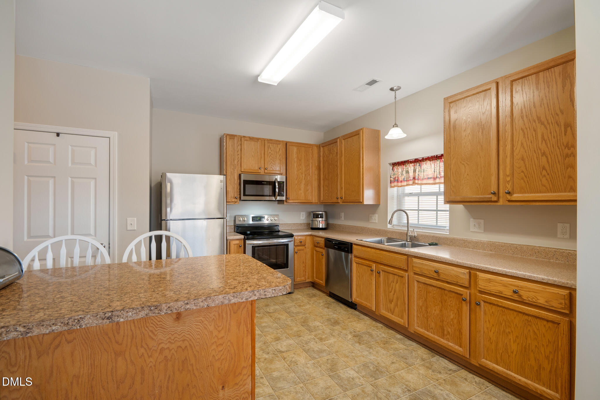 2019 Tennessee Road Durham, NC 27704 - Photo 12 of 28 a kitchen with stainless steel appliances granite countertop a sink a stove and cabinets