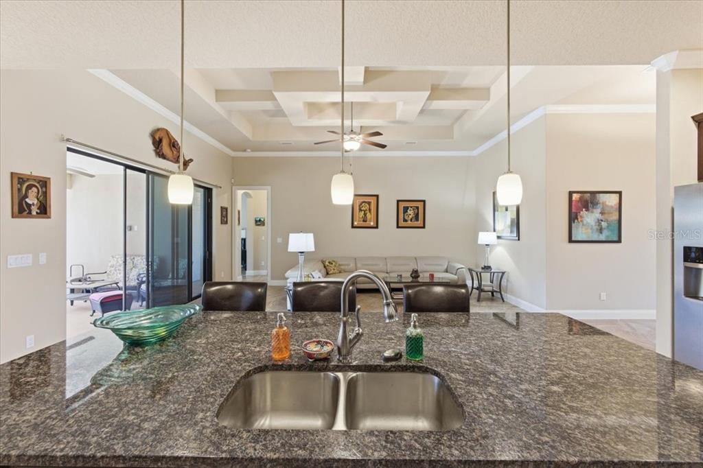 8 Cochran Lane Palm Coast, FL 32137 - Photo 12 of 40 a kitchen with a granite countertop sink and a mirror