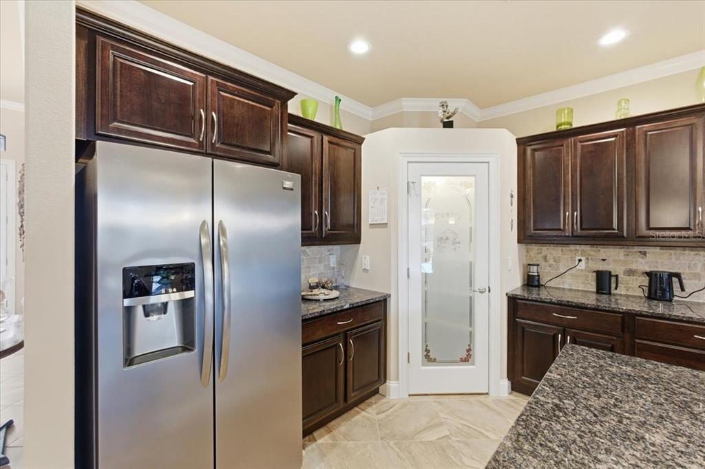 8 Cochran Lane Palm Coast, FL 32137 - Photo 13 of 40 a kitchen with stainless steel appliances granite countertop a refrigerator and a sink