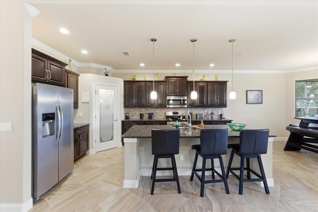 8 Cochran Lane Palm Coast, FL 32137 - Photo 14 of 40 a kitchen with a refrigerator and a dining table