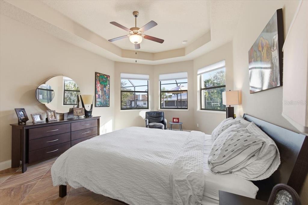 8 Cochran Lane Palm Coast, FL 32137 - Photo 19 of 40 a bedroom with a bed and a chandelier