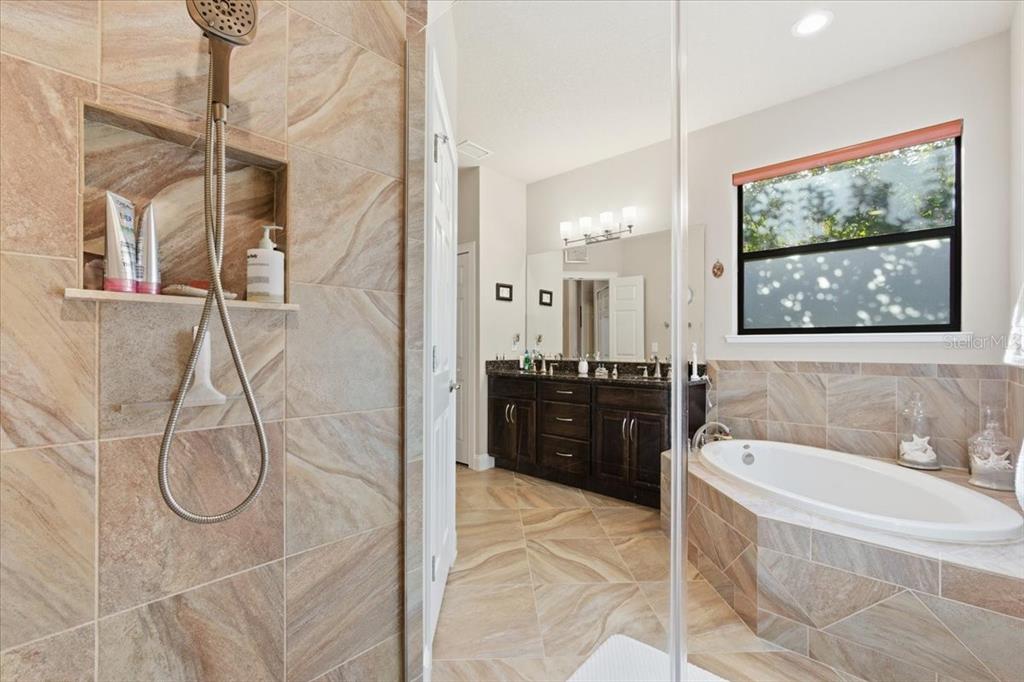 8 Cochran Lane Palm Coast, FL 32137 - Photo 23 of 40 a bathroom with a tub sink and mirror
