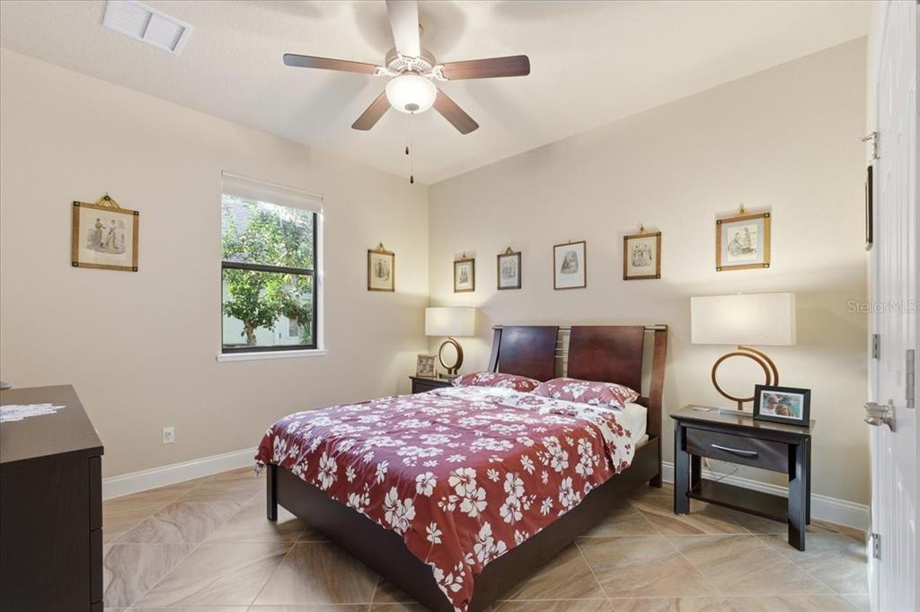 8 Cochran Lane Palm Coast, FL 32137 - Photo 25 of 40 a bedroom with a bed chandelier and a window
