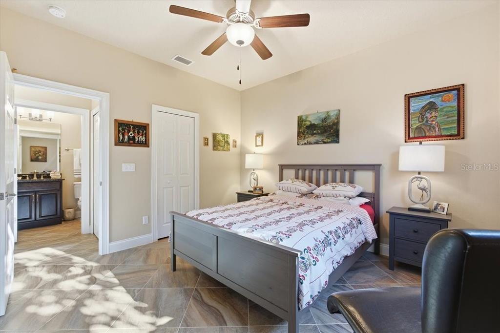 8 Cochran Lane Palm Coast, FL 32137 - Photo 26 of 40 a bedroom with a bed and a chandelier