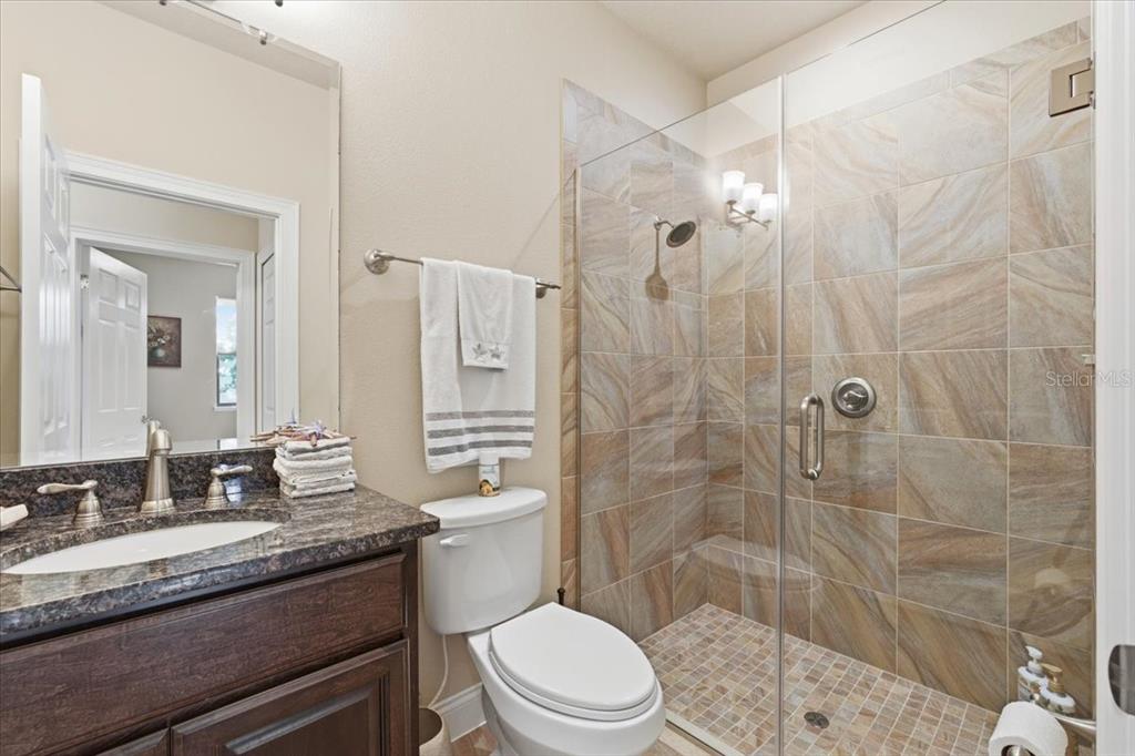 8 Cochran Lane Palm Coast, FL 32137 - Photo 27 of 40 a bathroom with a granite countertop sink toilet mirror and shower