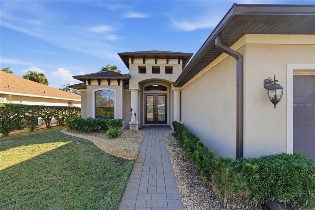 8 Cochran Lane Palm Coast, FL 32137 - Photo 35 of 40 a front view of a house with garden