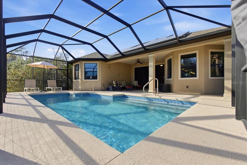 8 Cochran Lane Palm Coast, FL 32137 - Photo 36 of 40 a view of a backyard with table and chairs under an umbrella