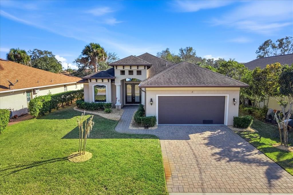 8 Cochran Lane Palm Coast, FL 32137 - Photo 37 of 40 a front view of a house with a yard and garage
