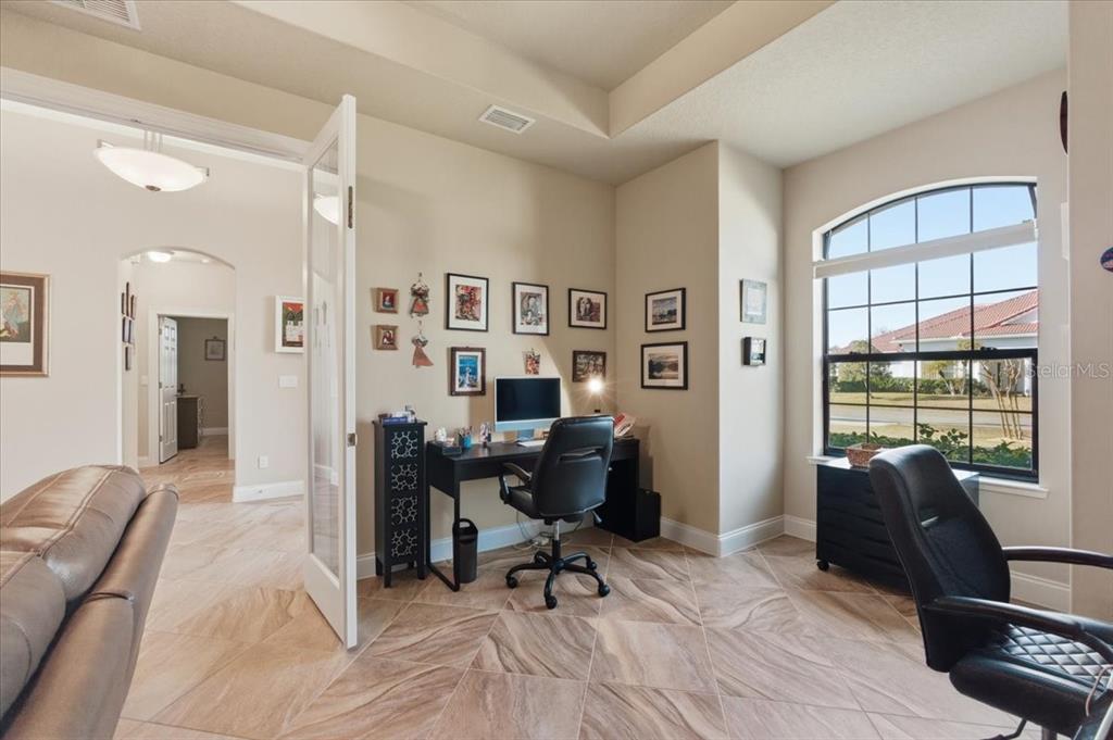8 Cochran Lane Palm Coast, FL 32137 - Photo 5 of 40 a view of a livingroom with workspace and a couch