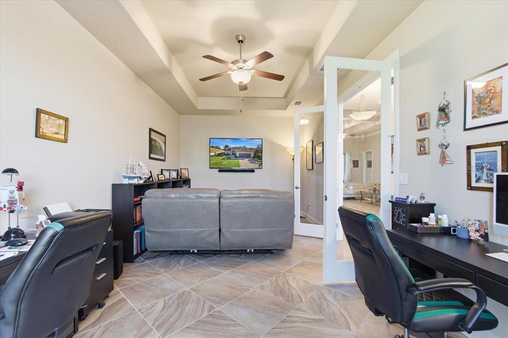 8 Cochran Lane Palm Coast, FL 32137 - Photo 6 of 40 a living room with furniture and a flat screen tv