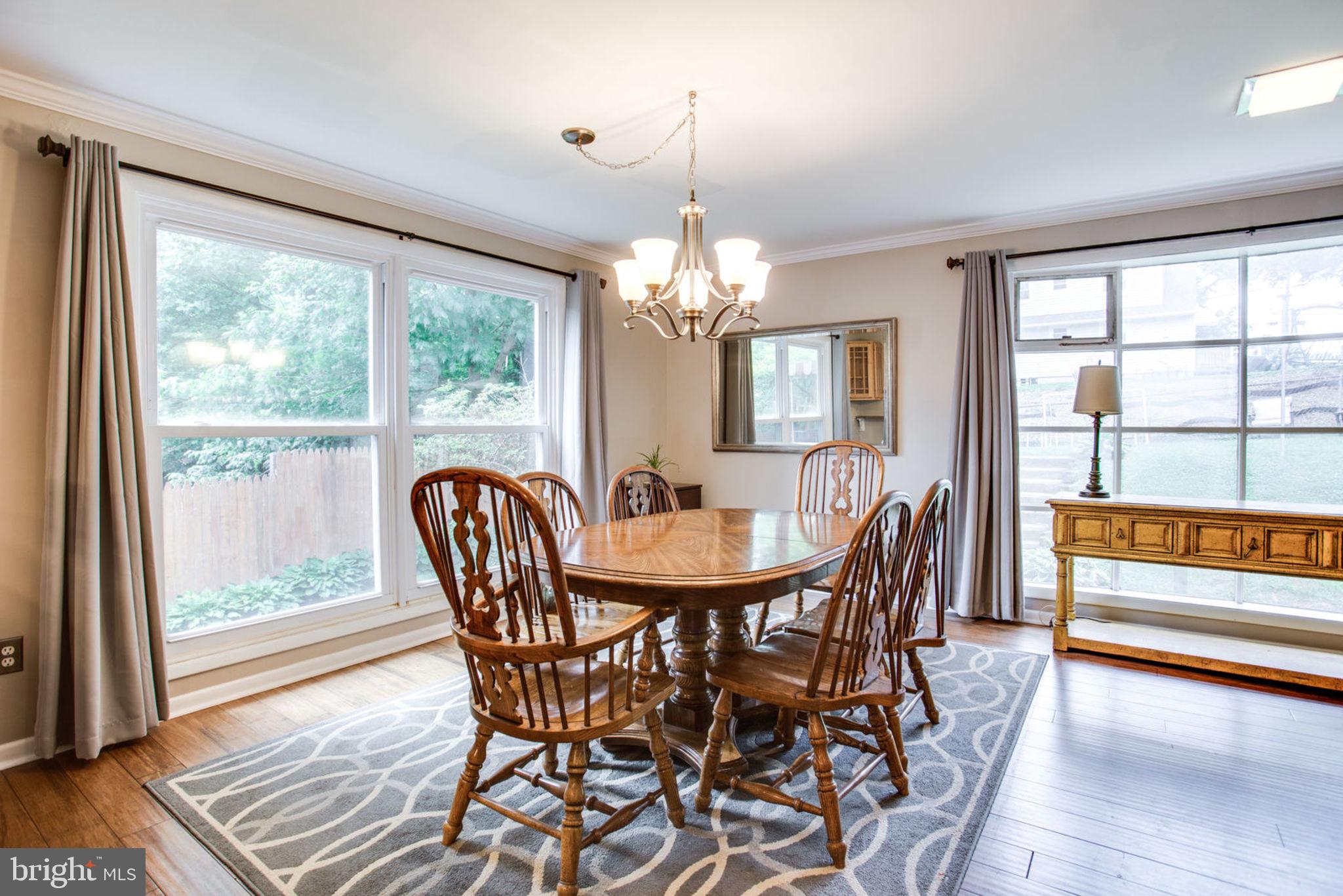909 Robin Road Silver Spring, MD 20901 - Photo 14 of 39 a view of a dining room with furniture wooden floor and chandelier