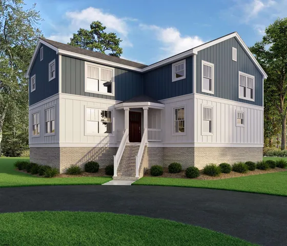 a front view of a house with a yard and trees