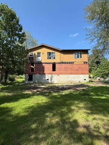 a front view of a house with a big yard