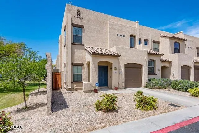 a front view of a white building with large windows