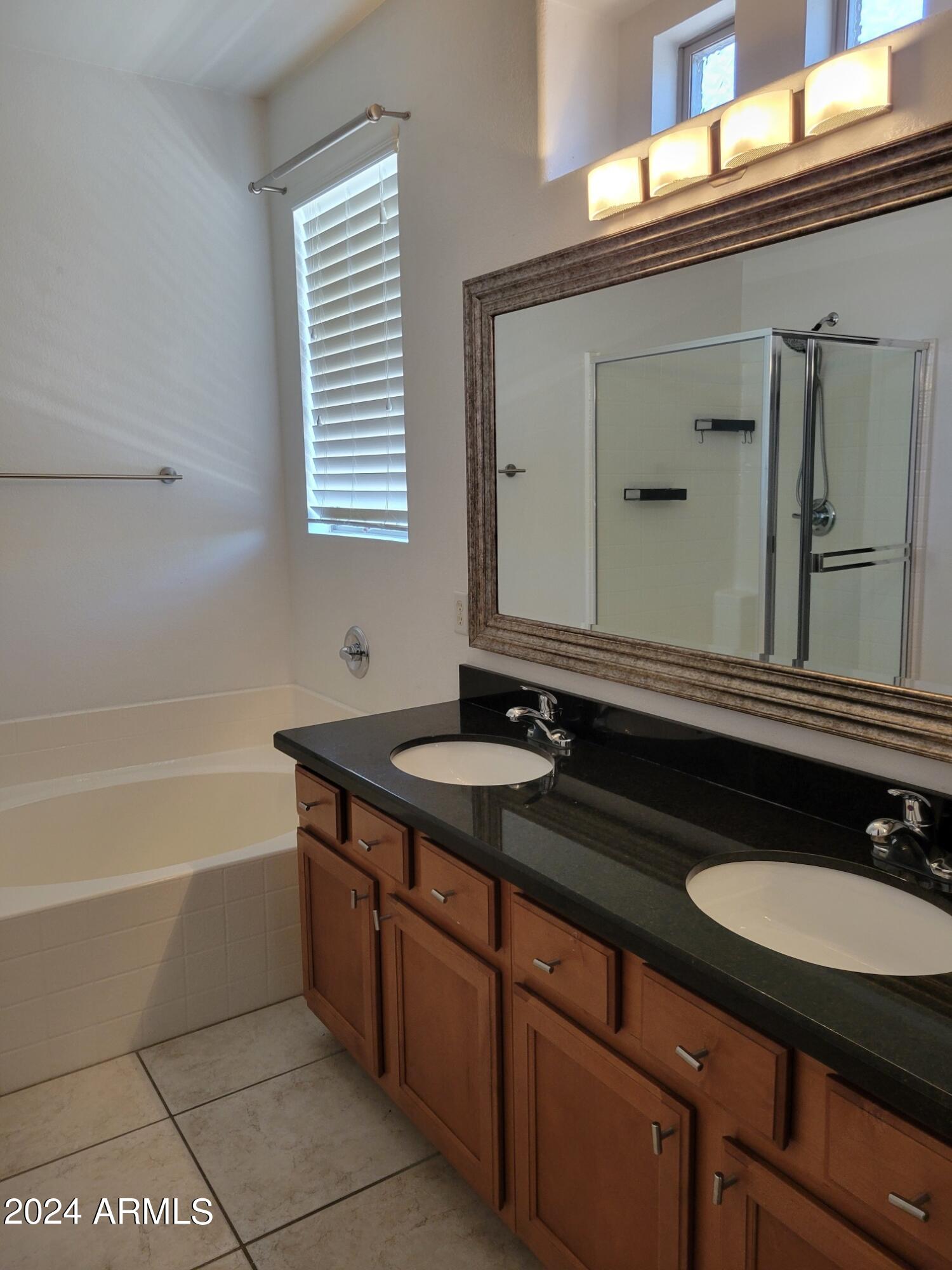 1886 East Don Carlos, Unit 164 Tempe, AZ 85281 - Photo 15 of 24 a bathroom with a granite countertop sink and a mirror