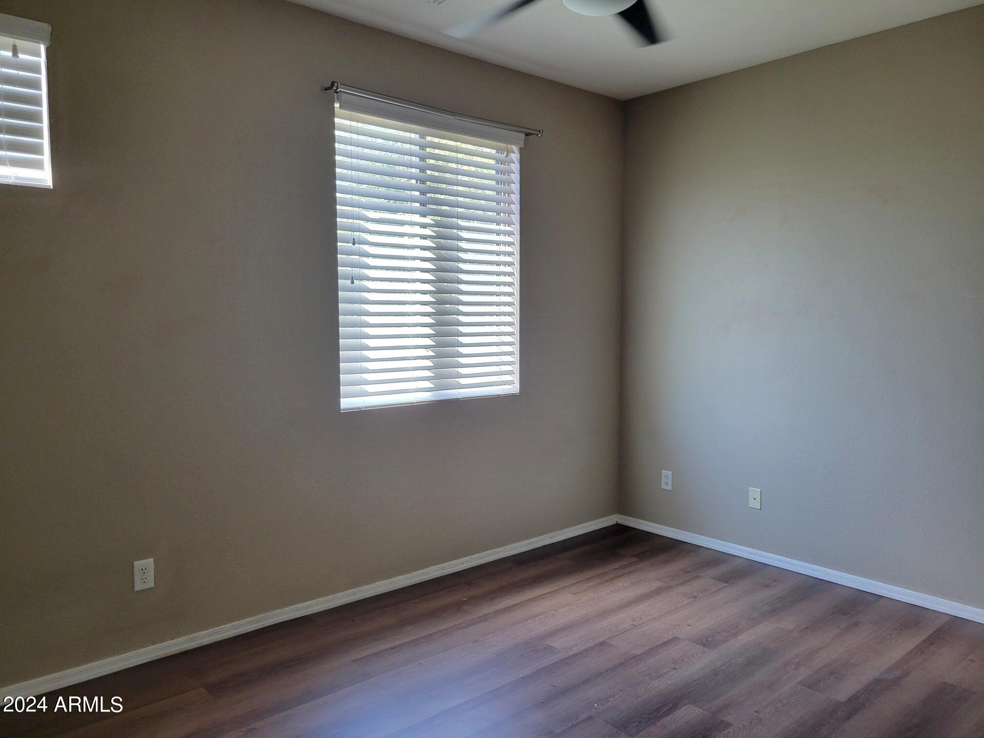 1886 East Don Carlos, Unit 164 Tempe, AZ 85281 - Photo 17 of 24 an empty room with wooden floor and windows