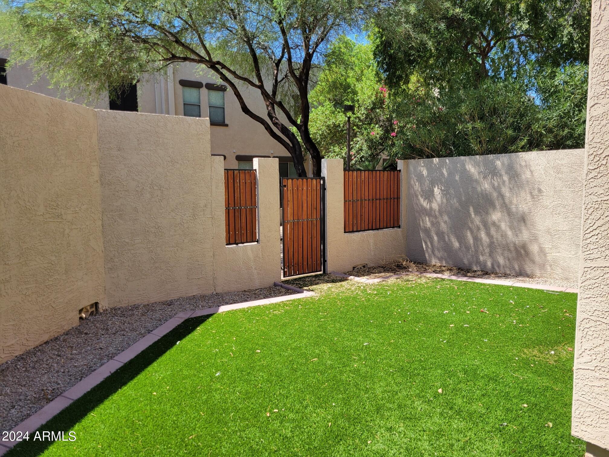 1886 East Don Carlos, Unit 164 Tempe, AZ 85281 - Photo 20 of 24 a backyard of a house with seating and yard