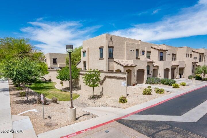 1886 East Don Carlos, Unit 164 Tempe, AZ 85281 - Photo 2 of 24 a view of a white house with table and chairs in front of it