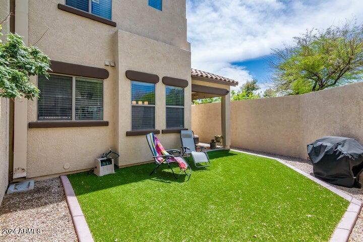 1886 East Don Carlos, Unit 164 Tempe, AZ 85281 - Photo 21 of 24 a view of a chair and table in backyard of the house