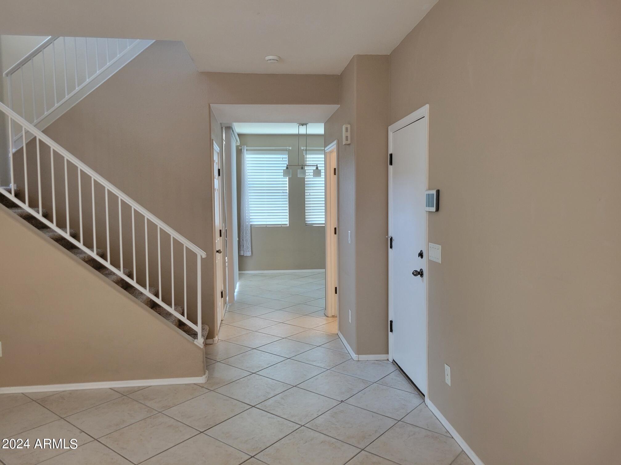 1886 East Don Carlos, Unit 164 Tempe, AZ 85281 - Photo 4 of 24 a view of a hallway with wooden floor and staircase