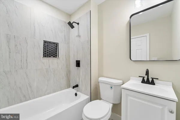 a bathroom with a toilet a sink and bathtub
