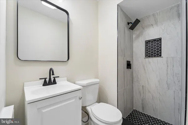 a bathroom with a toilet sink and mirror