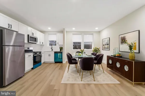 a kitchen with a refrigerator and a stove top oven