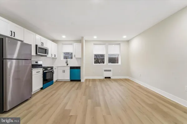 a kitchen with a refrigerator and a stove top oven