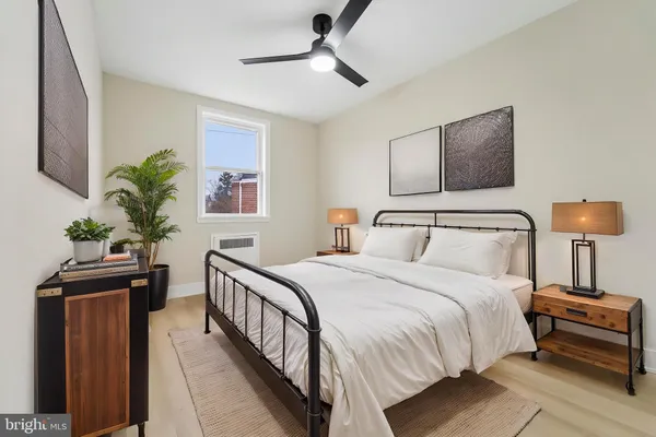 a bedroom with bed and a potted plant