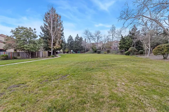 a view of a field with trees in the background