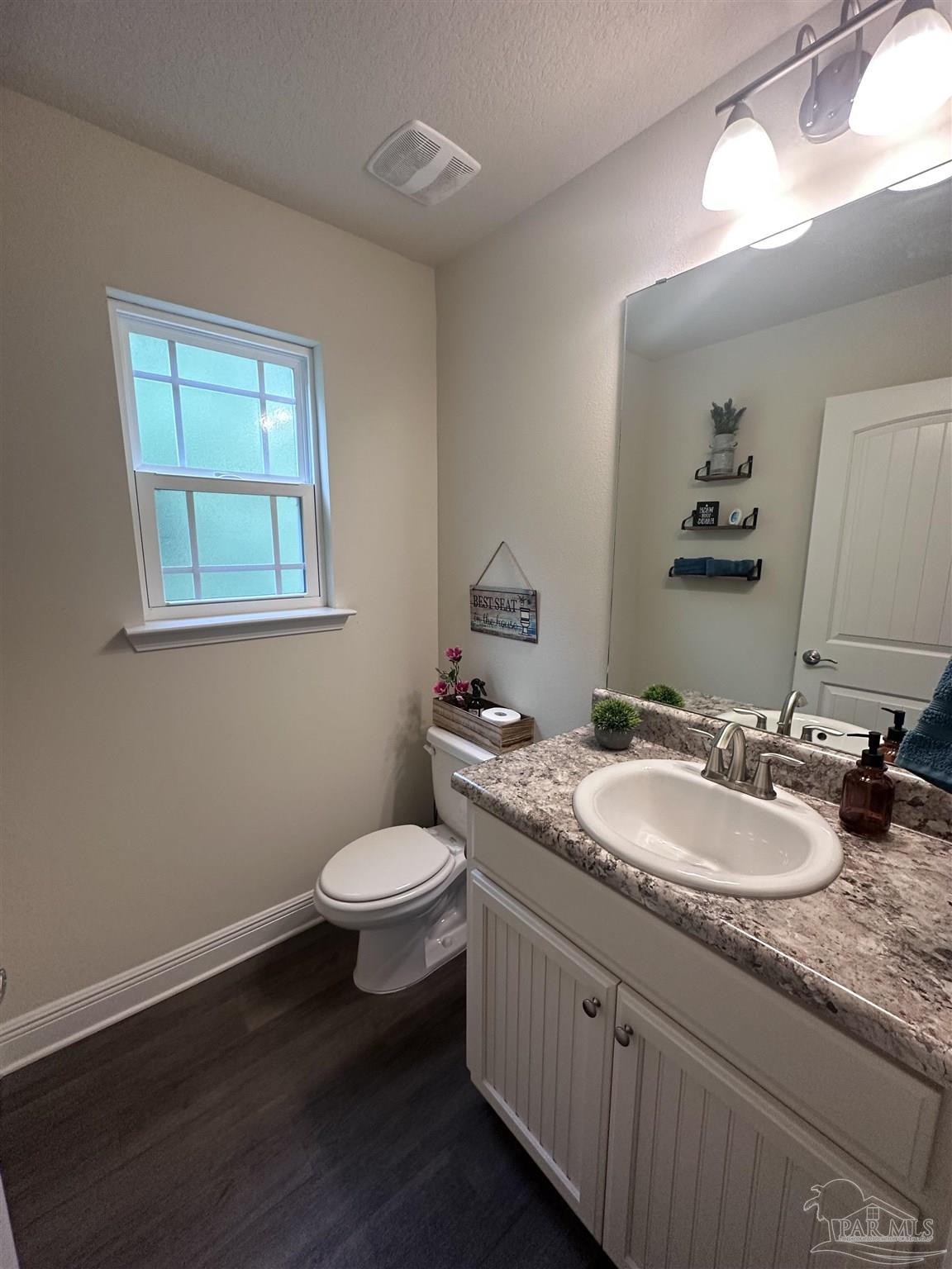 5217 Saufley Field Road Pensacola, FL 32526 - Photo 13 of 26 a bathroom with a granite countertop sink toilet and mirror