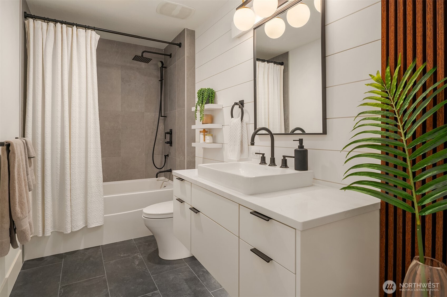 1730 North Northlake Way, Unit 415 Seattle, WA 98103 - Photo 25 of 40 a bathroom with a sink a toilet and shower