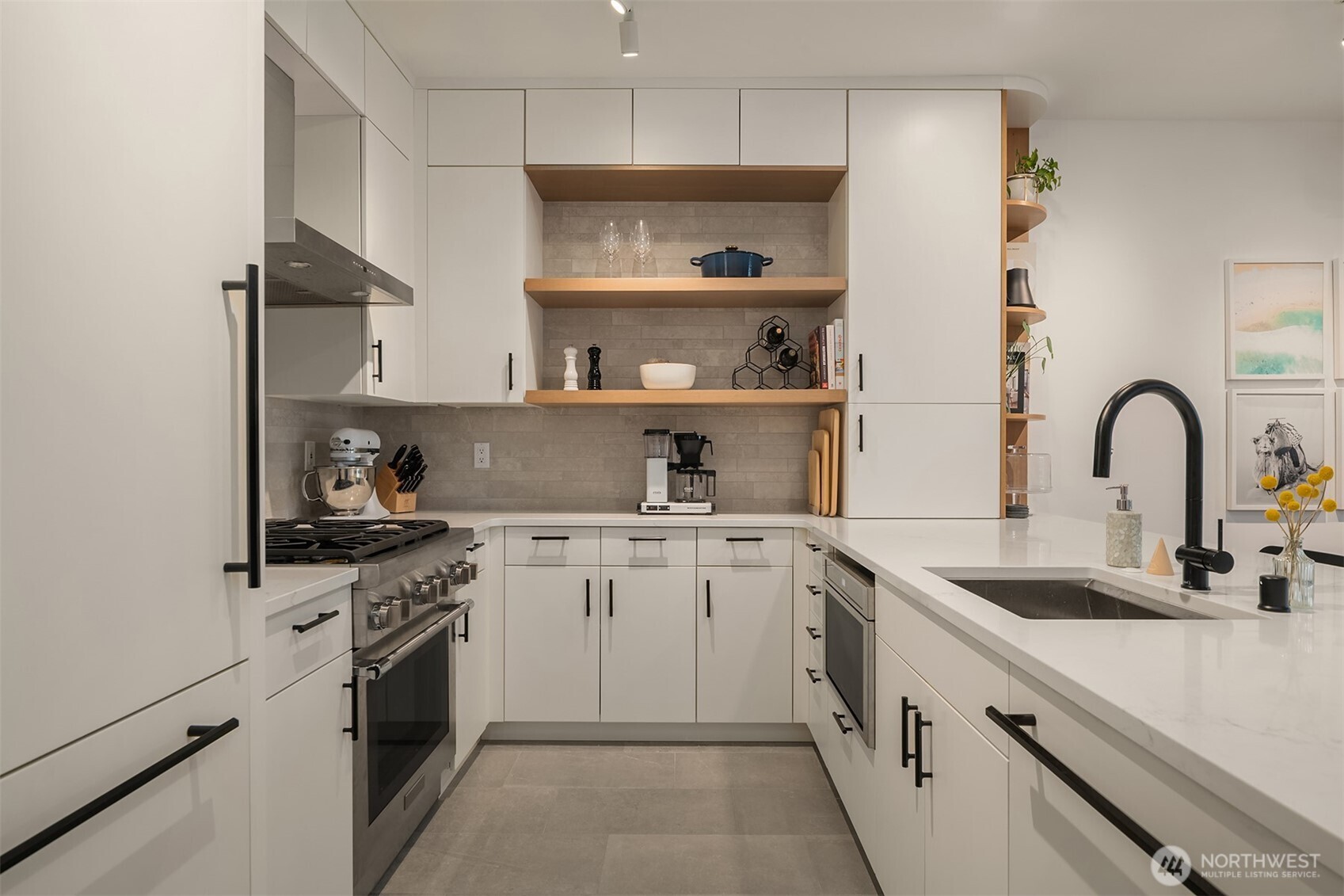 1730 North Northlake Way, Unit 415 Seattle, WA 98103 - Photo 4 of 40 a kitchen with white cabinets a sink and appliances