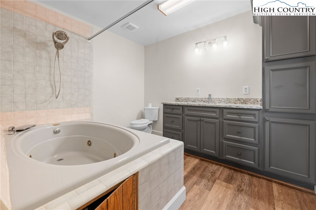 131 Hemlock Road Banner Elk, NC 28604 - Photo 12 of 37 a bathroom with a tub sink and cabinets