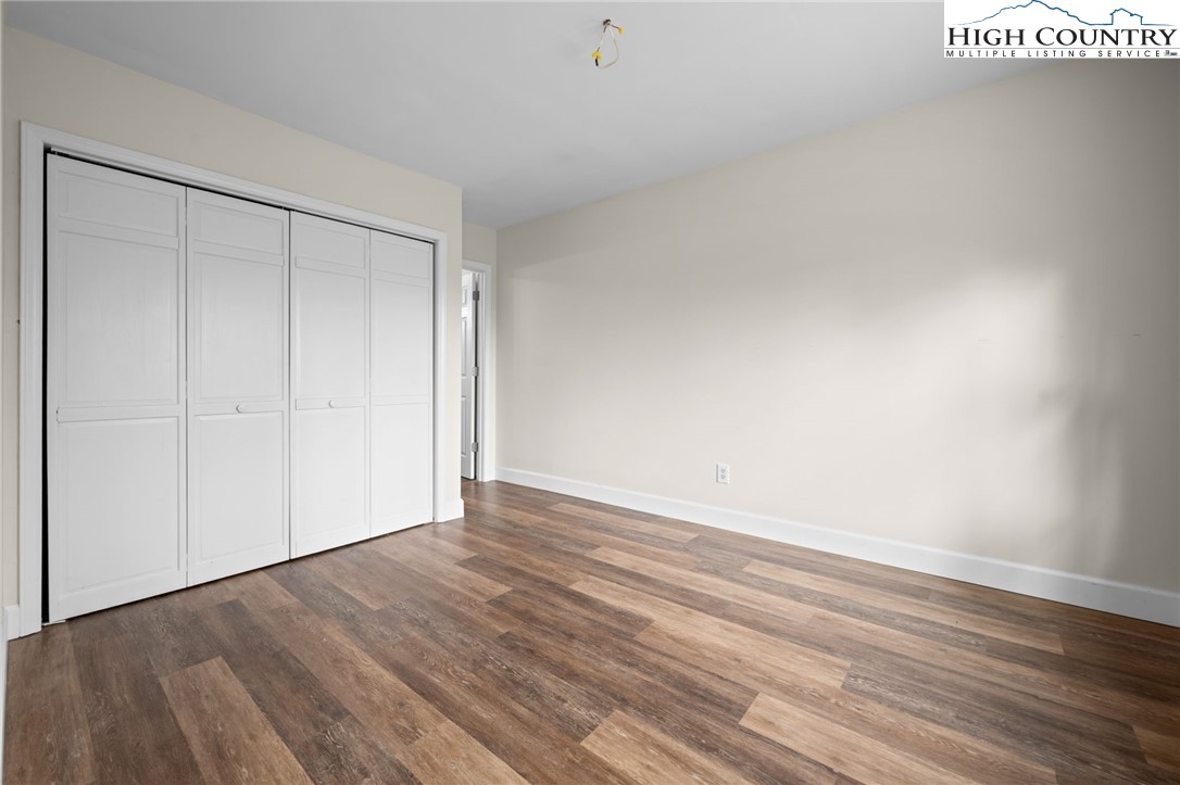 131 Hemlock Road Banner Elk, NC 28604 - Photo 13 of 37 a view of an empty room with wooden floor
