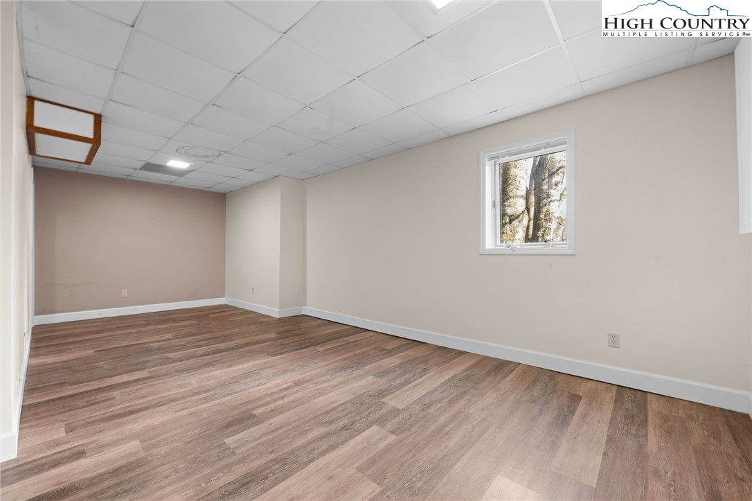 131 Hemlock Road Banner Elk, NC 28604 - Photo 23 of 37 a view of an empty room with wooden floor and a window