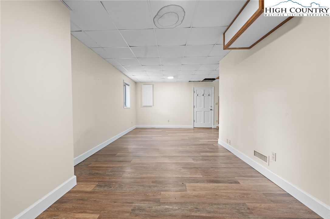 131 Hemlock Road Banner Elk, NC 28604 - Photo 24 of 37 a view of an empty room with wooden floor
