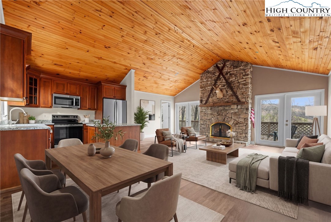 131 Hemlock Road Banner Elk, NC 28604 - Photo 3 of 37 a living room with furniture a fireplace and a flat screen tv