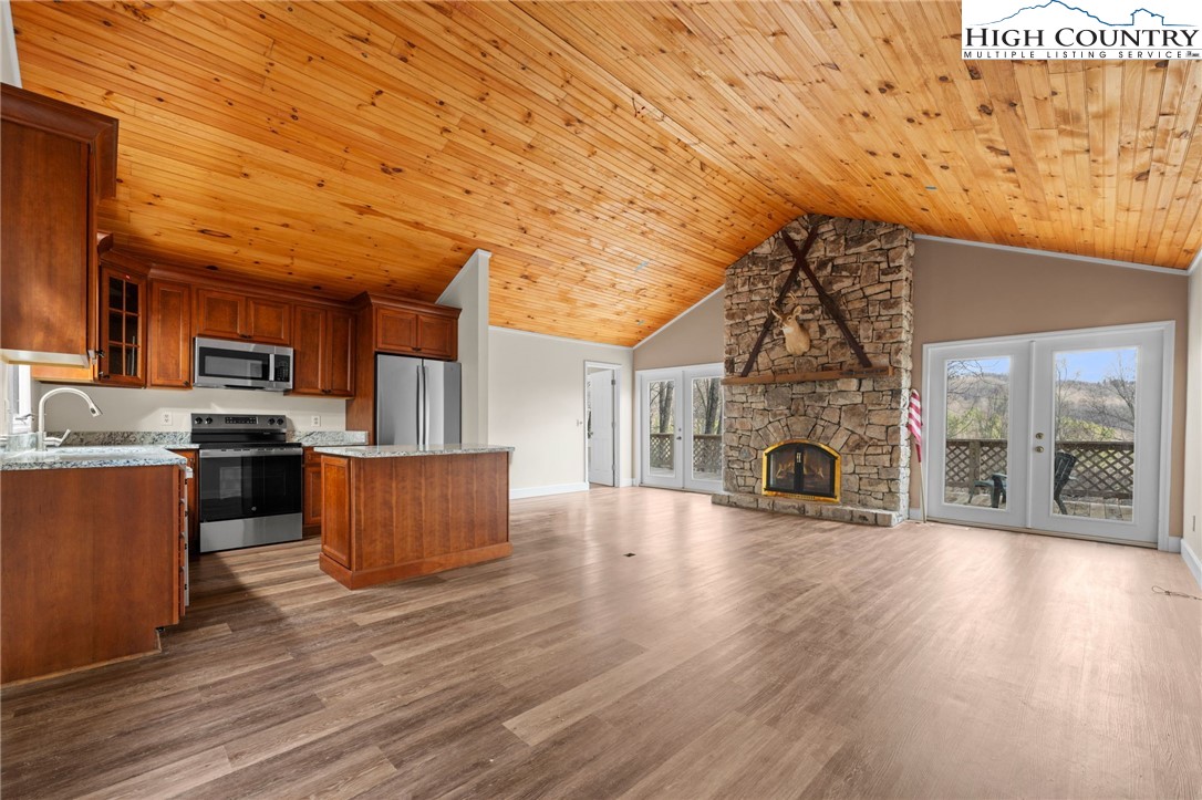 131 Hemlock Road Banner Elk, NC 28604 - Photo 4 of 37 a living room with stainless steel appliances wooden floors and fireplace