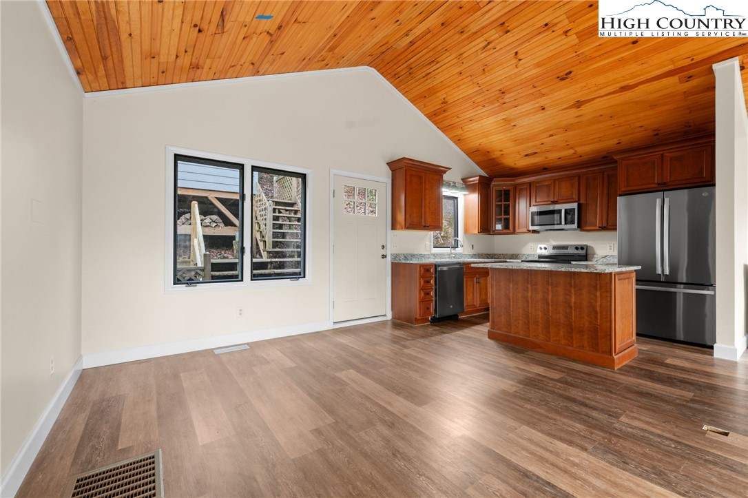 131 Hemlock Road Banner Elk, NC 28604 - Photo 5 of 37 a kitchen with stainless steel appliances granite countertop a stove cabinets and wooden floor