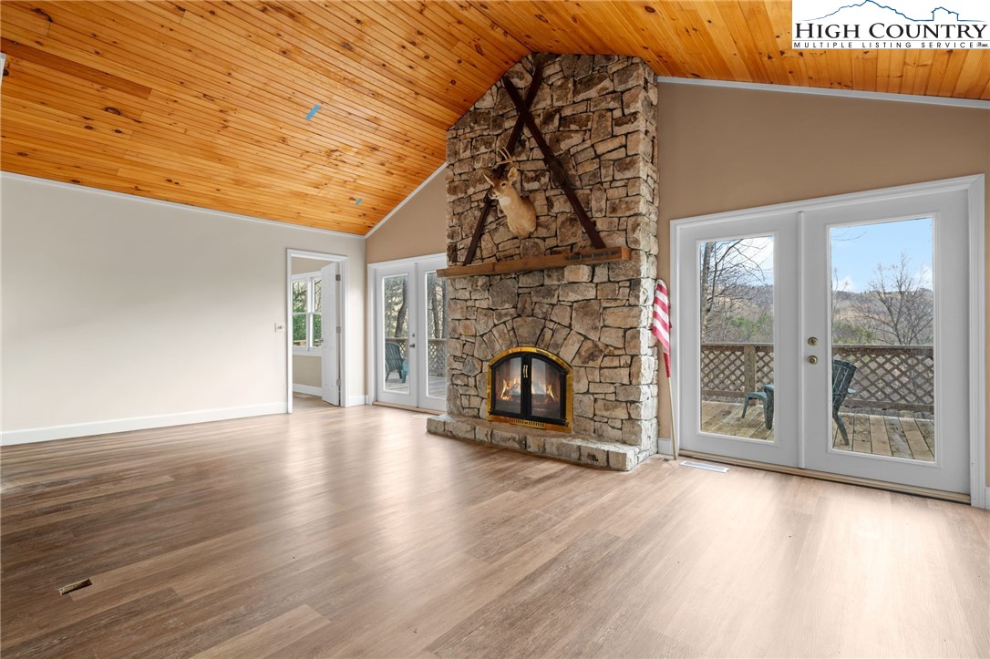 131 Hemlock Road Banner Elk, NC 28604 - Photo 6 of 37 a view of a livingroom with wooden floor and a fireplace