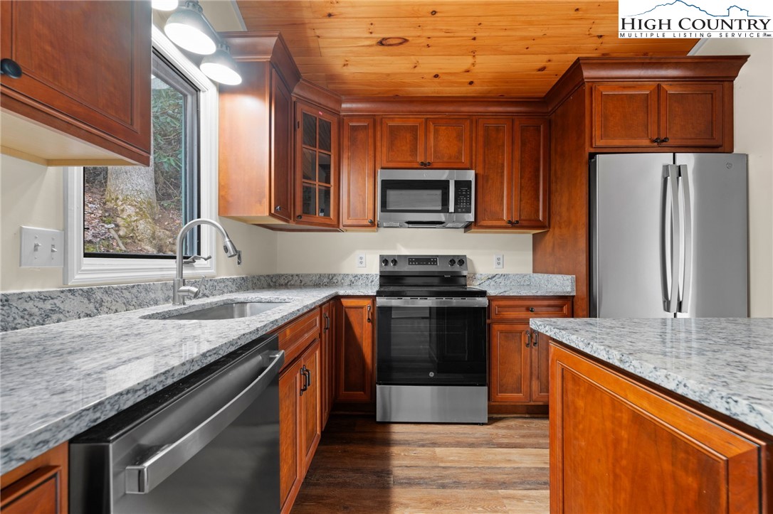 131 Hemlock Road Banner Elk, NC 28604 - Photo 10 of 37 a kitchen with stainless steel appliances granite countertop a sink stove microwave and refrigerator