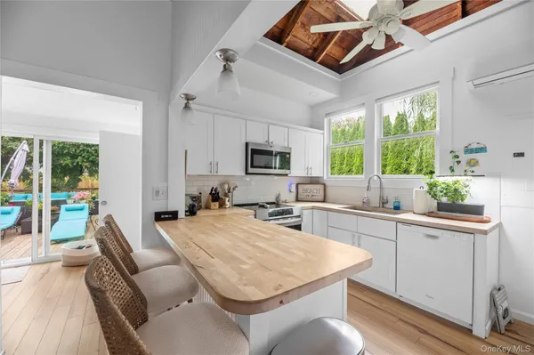 a kitchen with a stove a sink a dining table and chairs